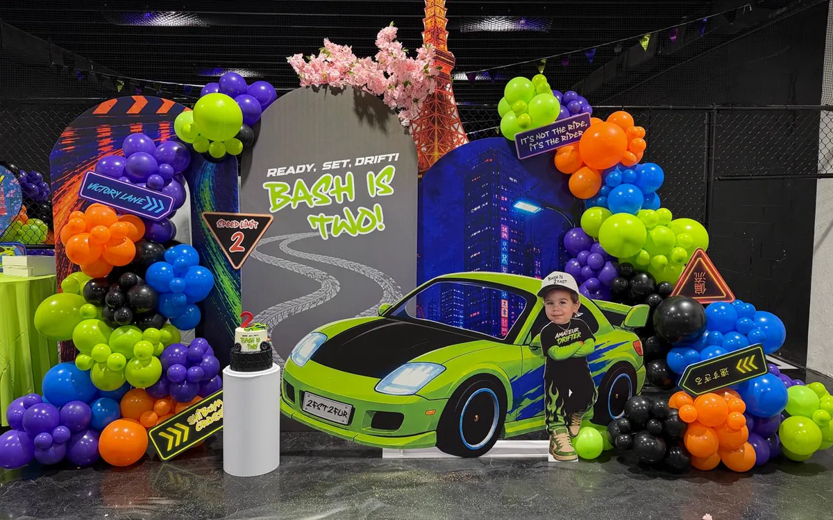 A racing themed birthday with printed panels and a neon balloon garland