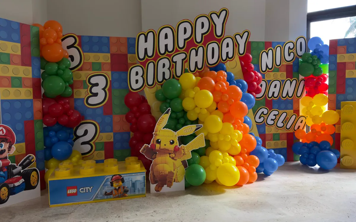 Printed brick panels and character cutouts at a LEGO themed birthday