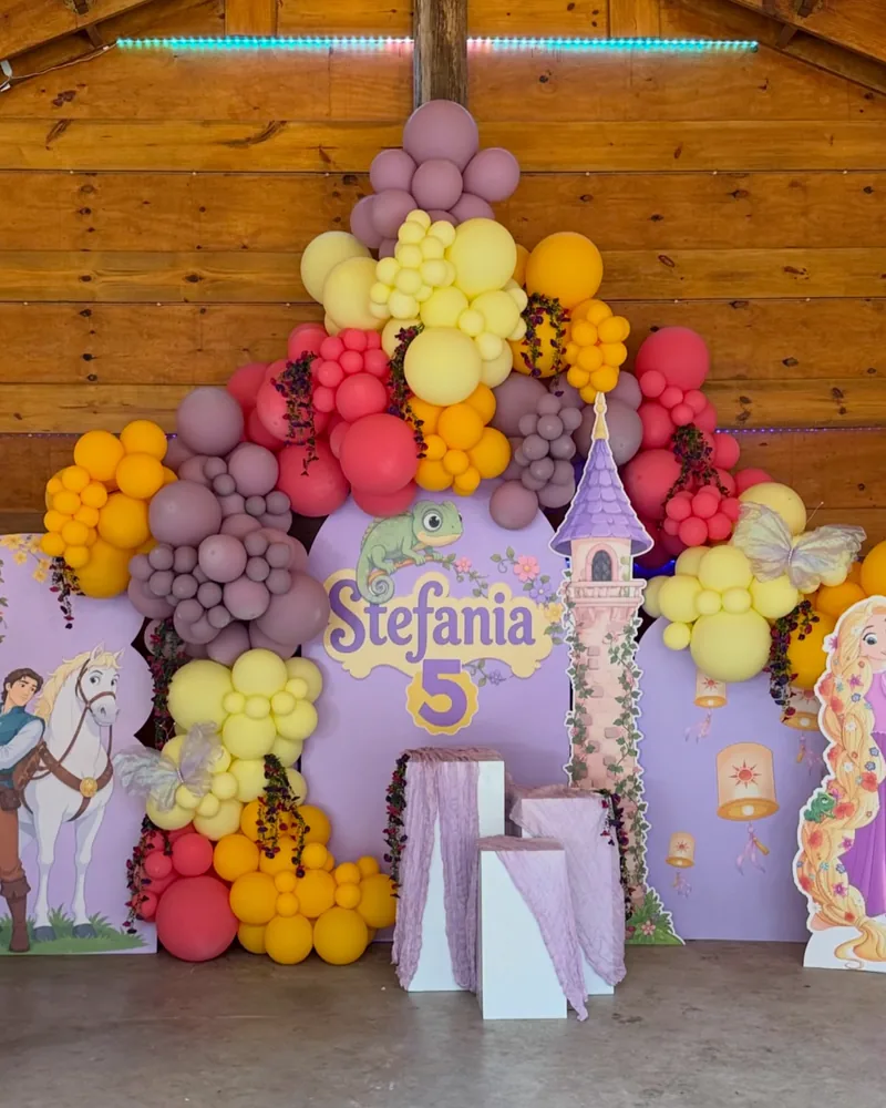 Draped plinths and printed panels at a fairytale themed party